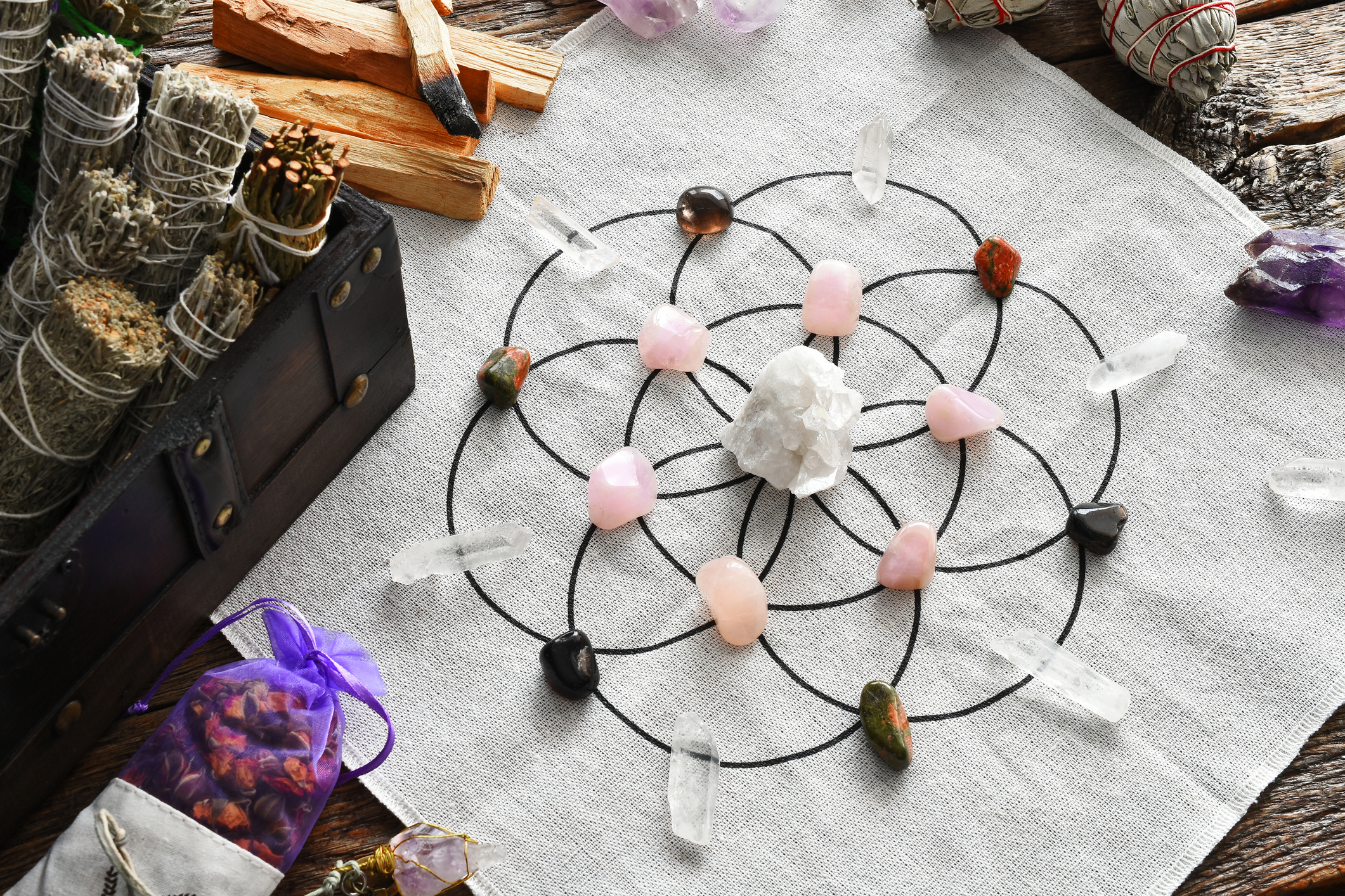 A top view image of a healing crystal grid using healing crystals and sacred geometry.